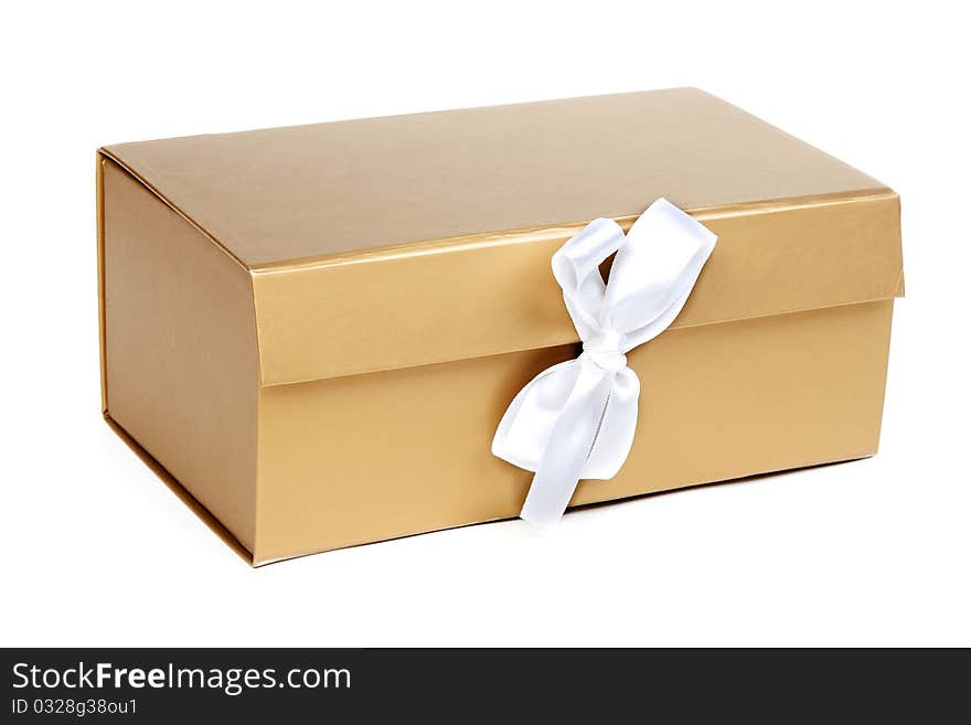 Golden gift box with a bow on a white background