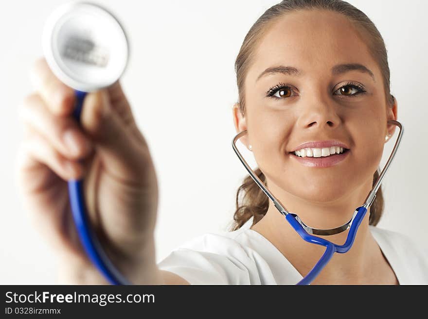 Young woman doctor or nurse holding a stethoscope. Young woman doctor or nurse holding a stethoscope