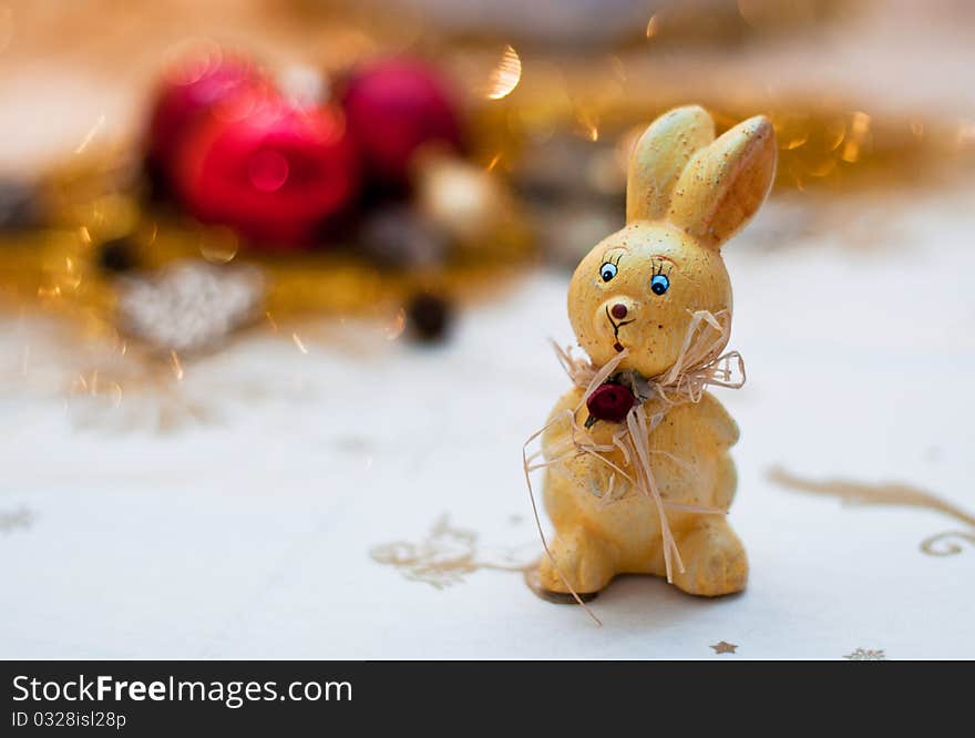 Yellow bunny christmas toy on a shiny background. Yellow bunny christmas toy on a shiny background