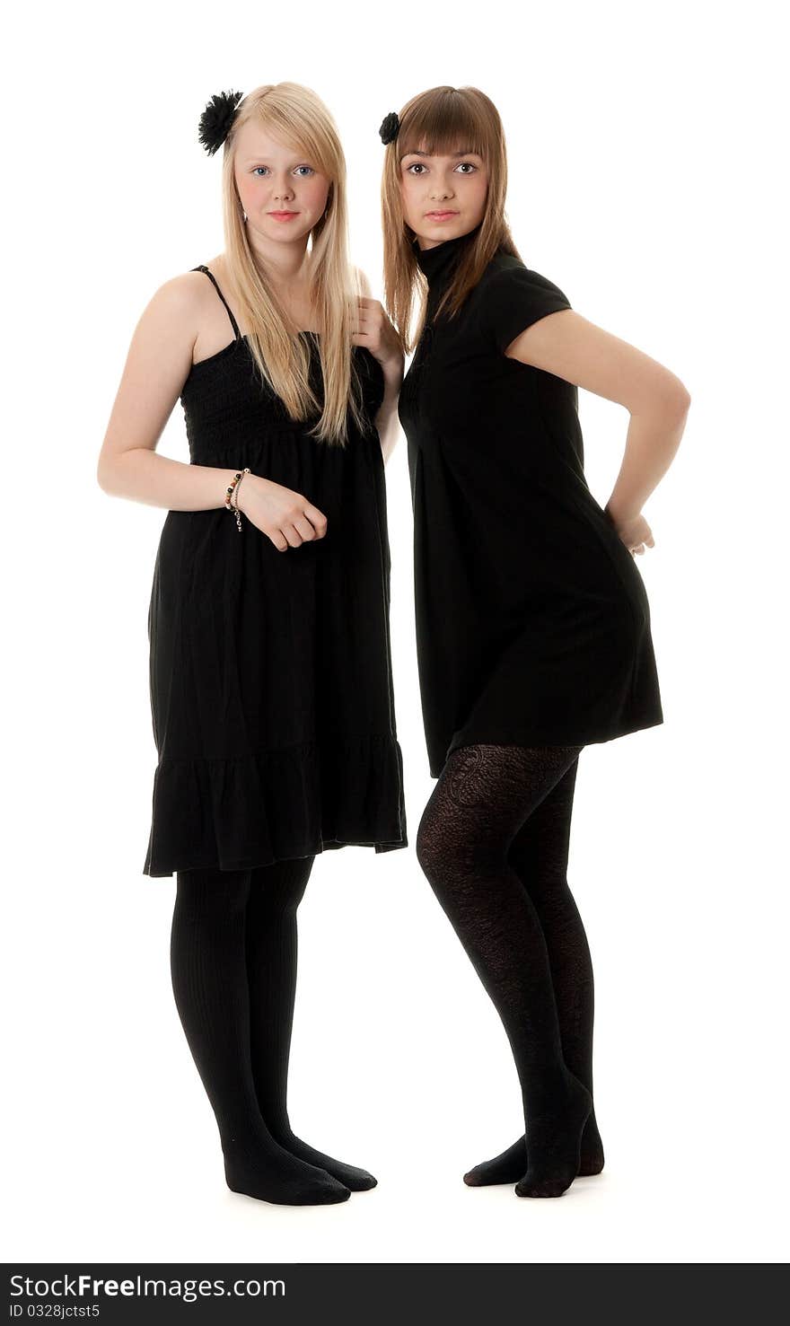 Two girls in black dresses with a white background