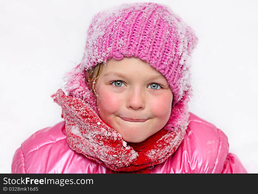 Little girl in winter pink hat in snow . Little girl in winter pink hat in snow .