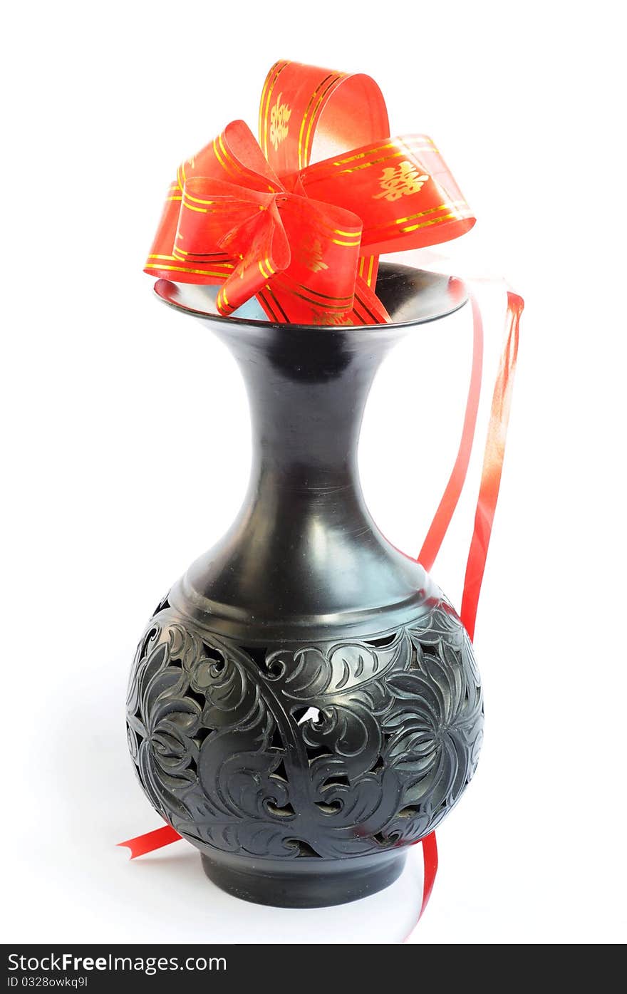 Black vase with artificial flowers