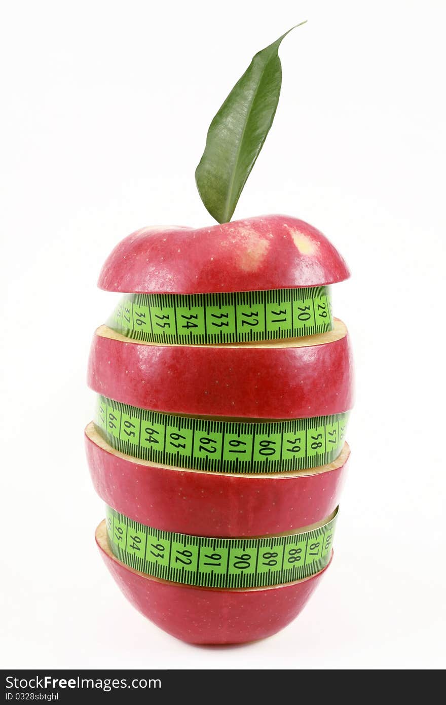 Red apple and green measured tape is isolated on a white background