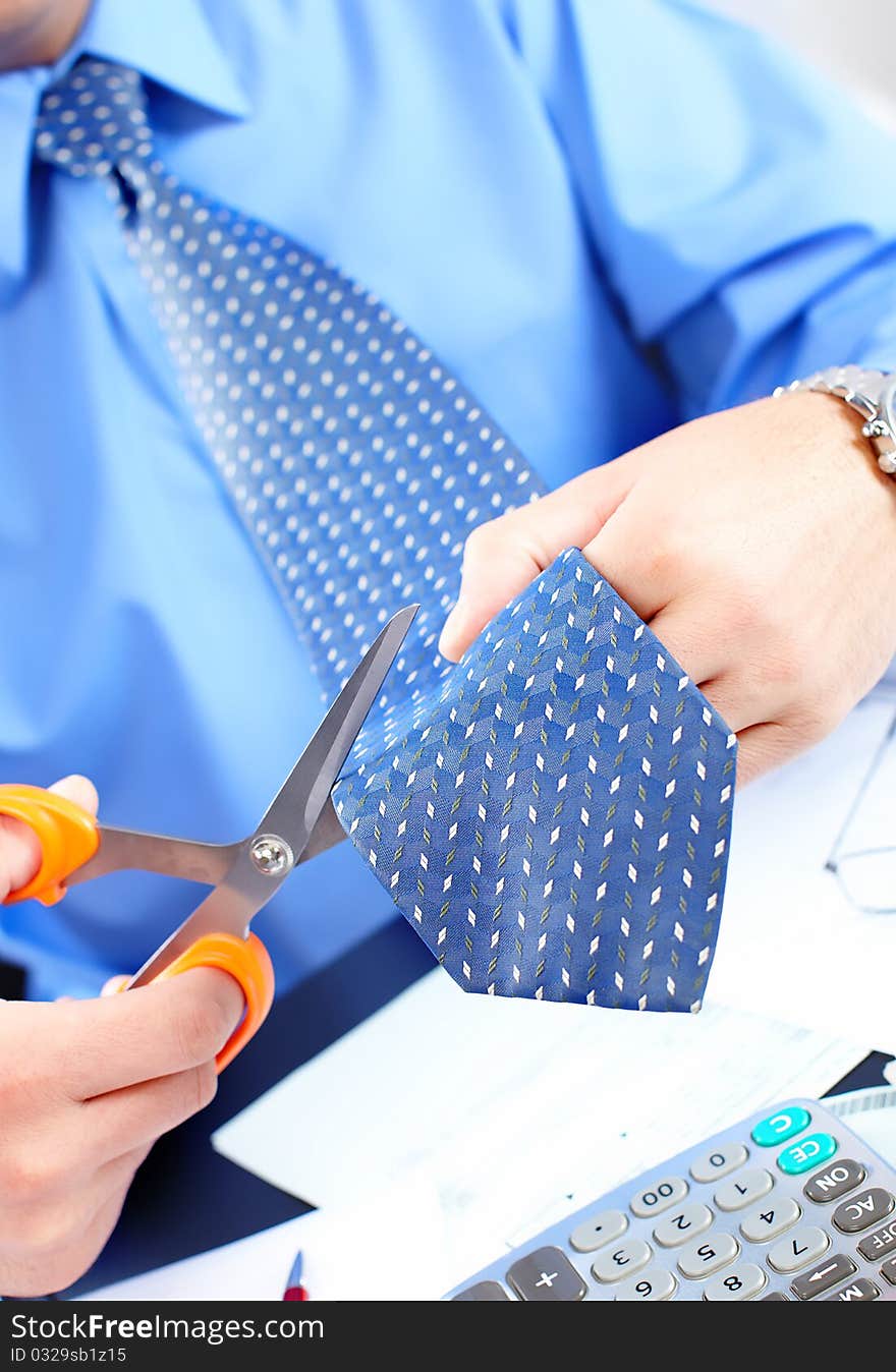 Businessman cutting the tie