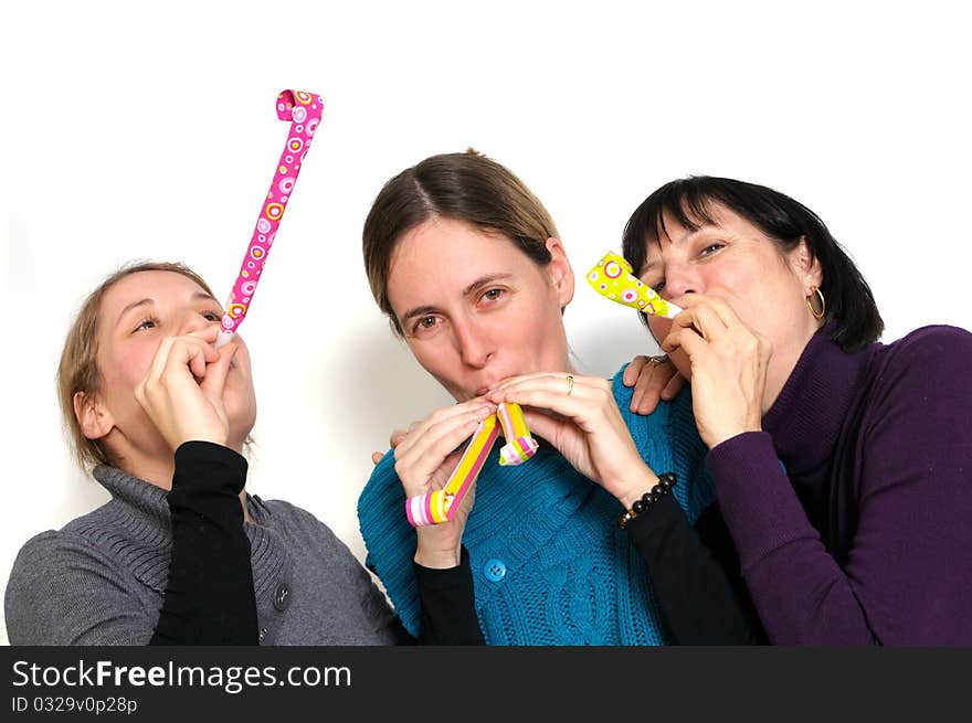 Two young women and her mother celebrating New year's eve. Shot taken in front of white background. Two young women and her mother celebrating New year's eve. Shot taken in front of white background