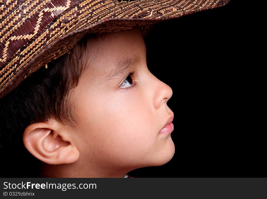 Six years old child looking with hat on black background. Six years old child looking with hat on black background