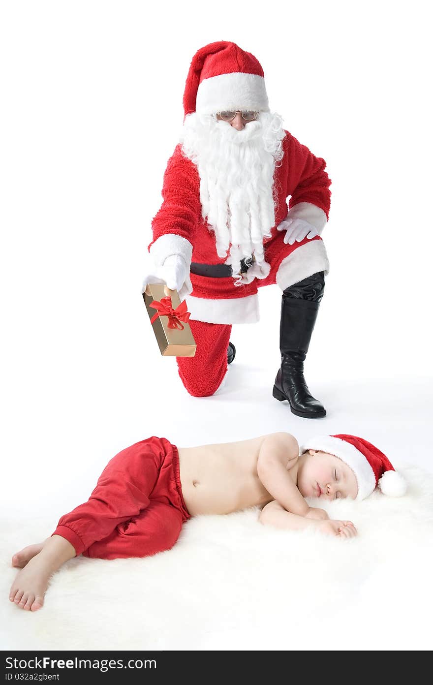 Santa is giving gift to sleeping baby