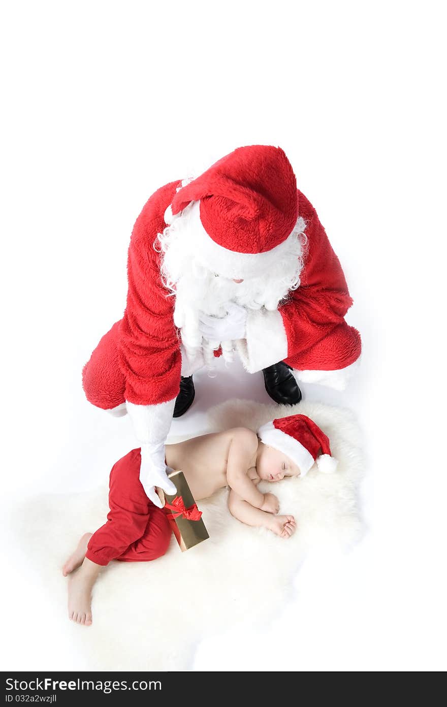 Santa is giving gift to sleeping baby