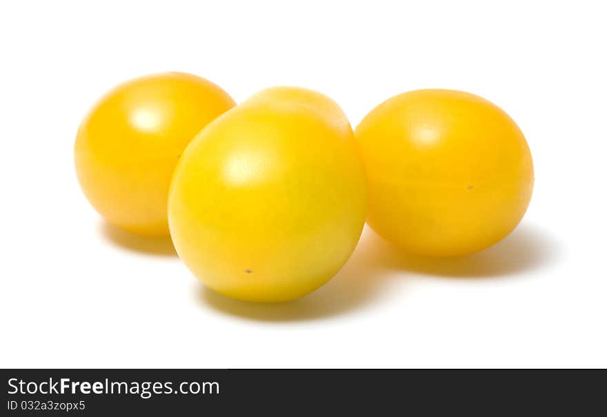 Three yellow tomato on a white background. Three yellow tomato on a white background.