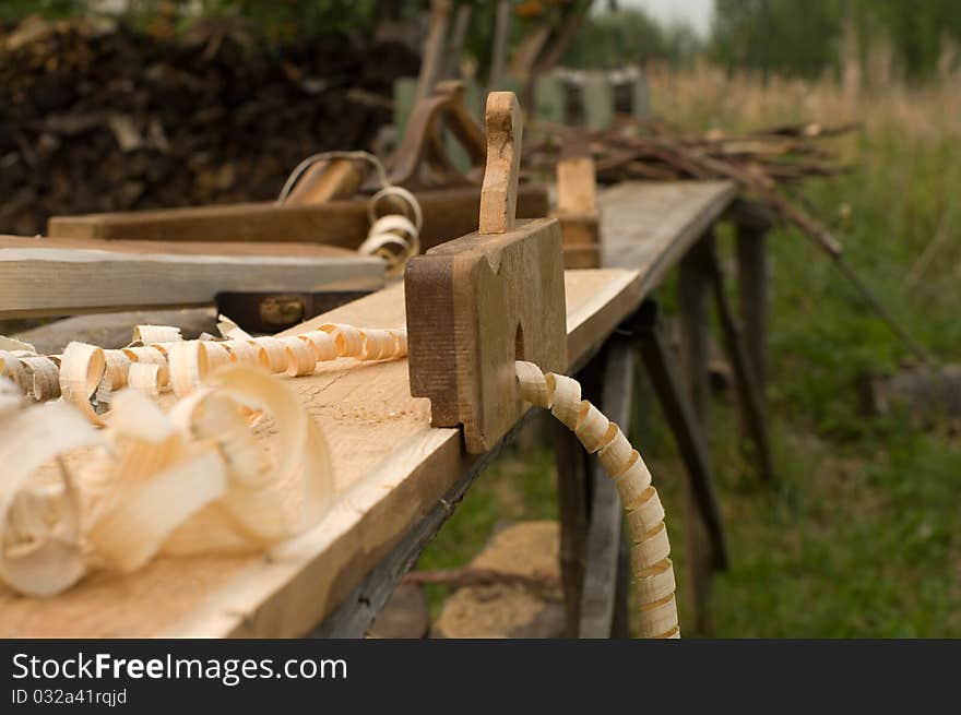 Closeup shot of old wooden plane on the workbench. Closeup shot of old wooden plane on the workbench.