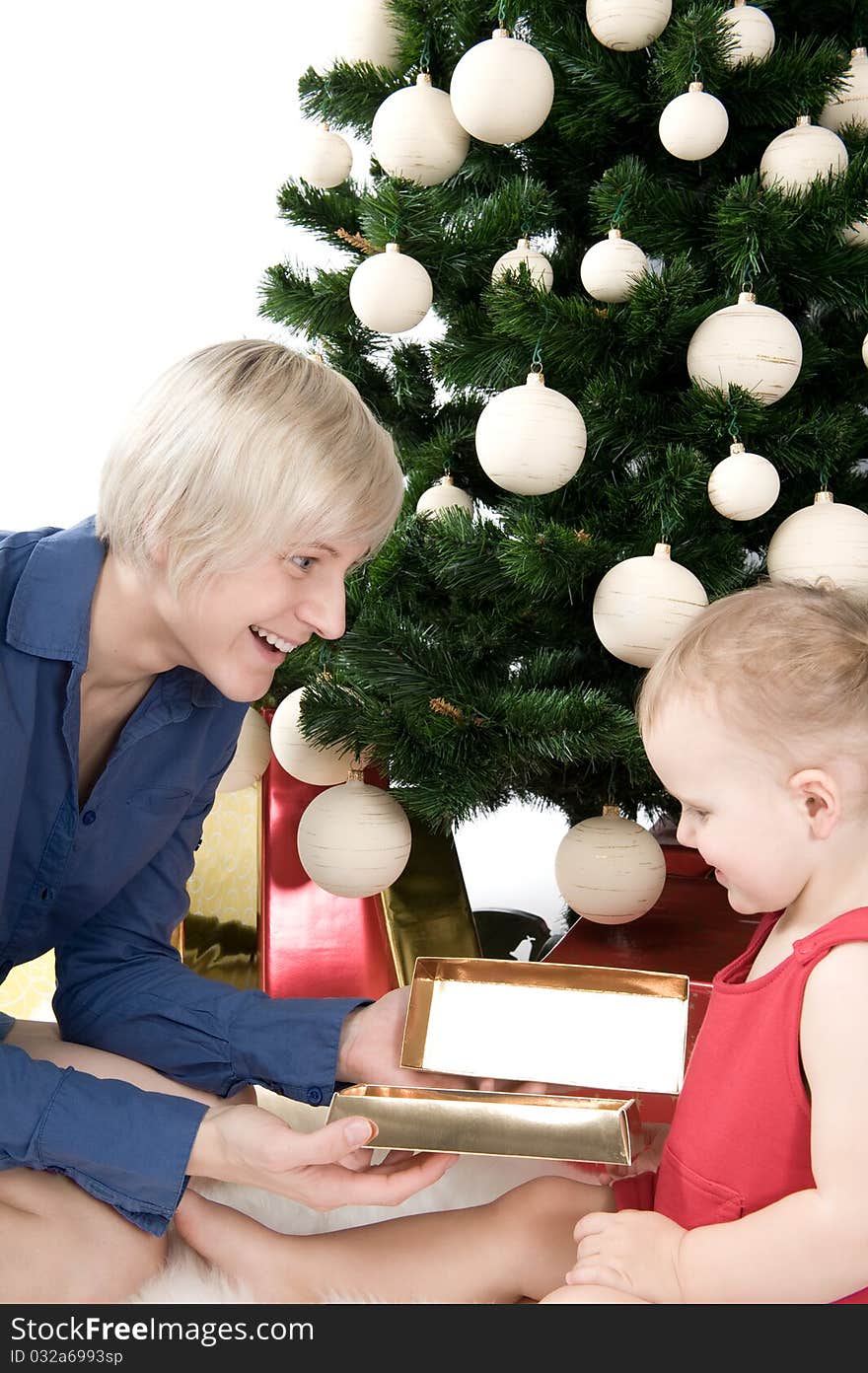 Mother is giving a gold gift to little baby