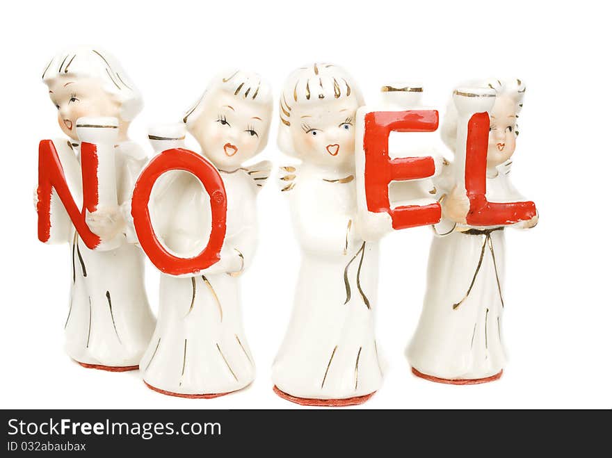 Singing four angels with Noel sigh candle holders isolated on the white background. Singing four angels with Noel sigh candle holders isolated on the white background.