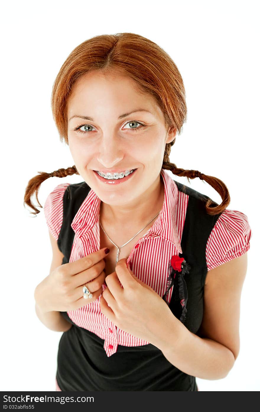 Smiling redhead female with braces and braids looking at camera, isolated. Smiling redhead female with braces and braids looking at camera, isolated