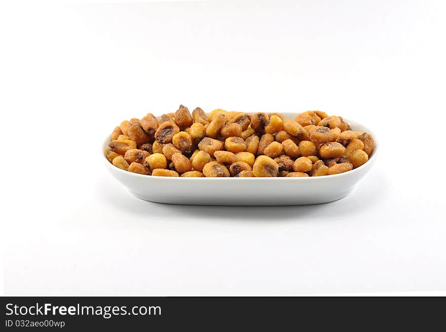 Fried corn presented on a dish over a white background