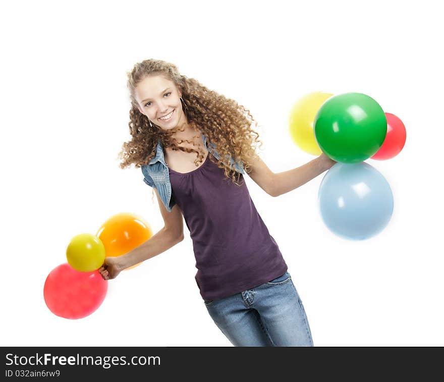 Studio portrait of young happy girl with colorful balloons over white