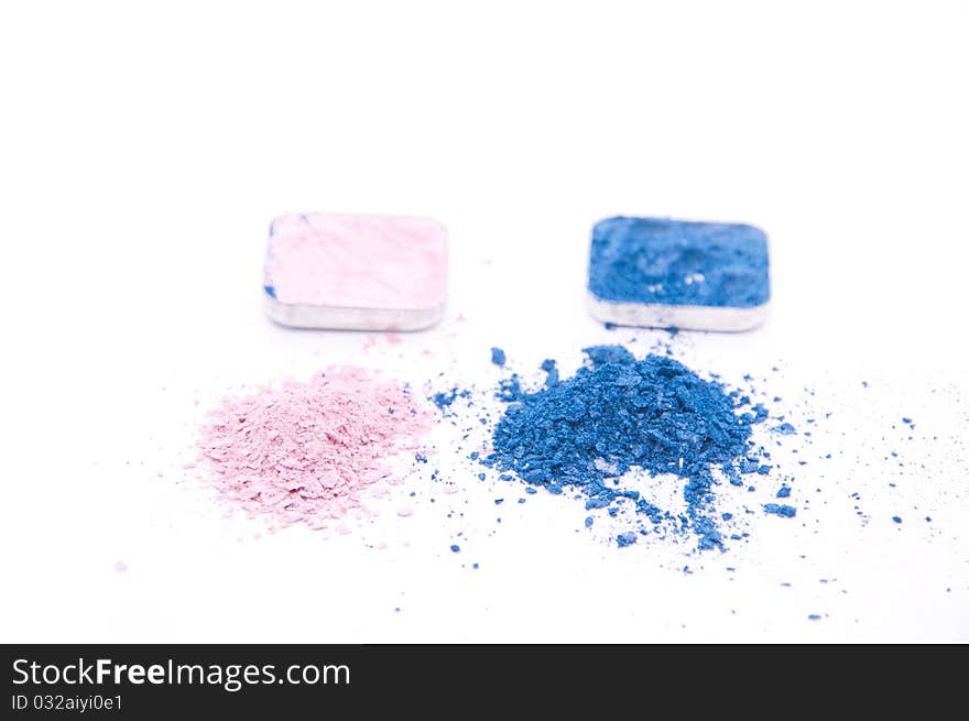 Crushed colored makeup on white background