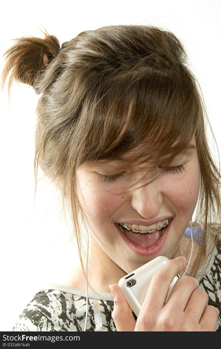 Young girl singing and listening music