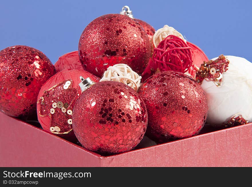 Gift box filled with ornamental red balls. shooted in studio using strobes