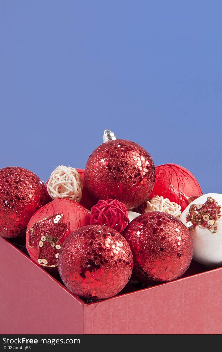 Gift box filled with ornamental red balls. shooted in studio using strobes