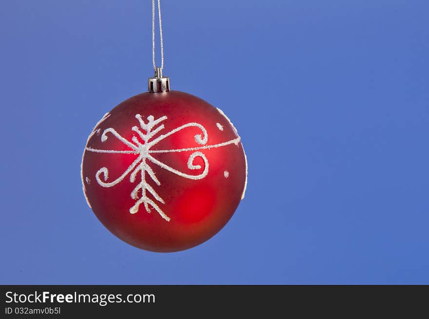 Isolated christmass red ball shooted on a blue background