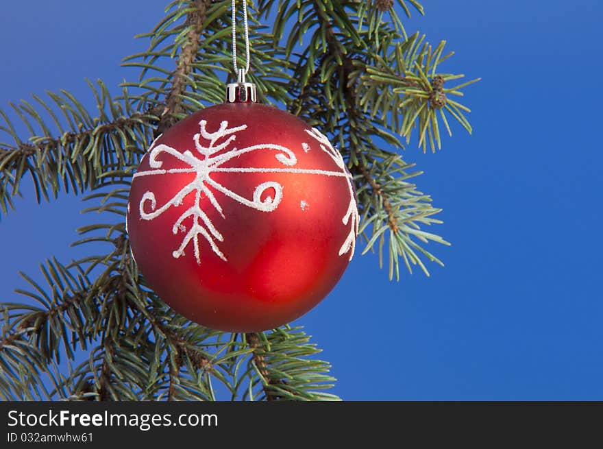 Isolated christmass red ball shooted on a blue background. Isolated christmass red ball shooted on a blue background