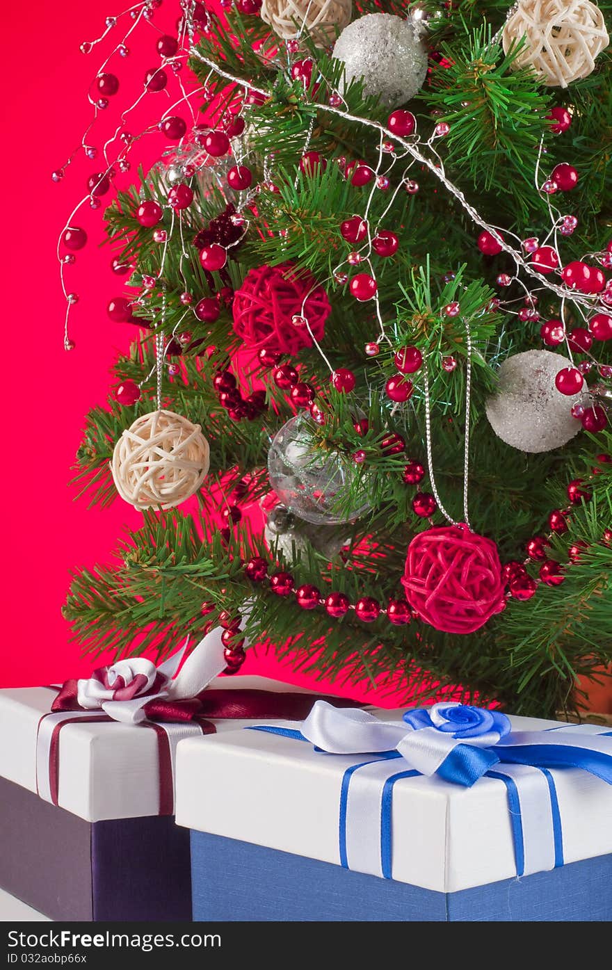 Christmas tree and gifts shooted in studio with red background