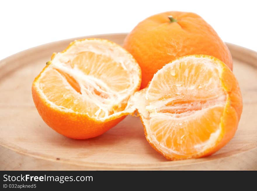 Mandarin on a wooden plate. Mandarin on a wooden plate