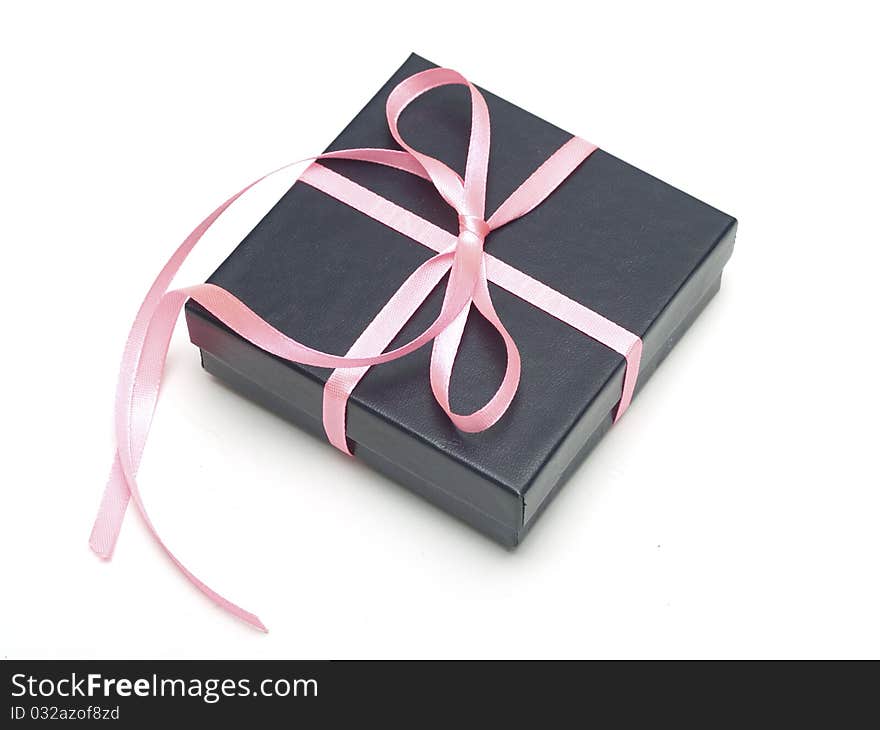 Gift black box tied with satin ribbon on gray