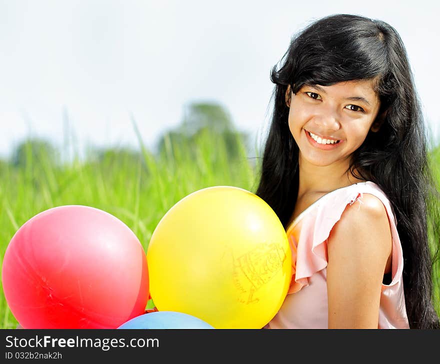 Portrait of teenage girl smiling while holding any balloons. Portrait of teenage girl smiling while holding any balloons