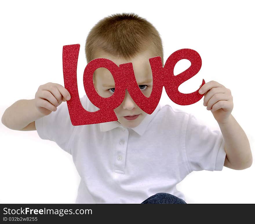 Boy holding a love sign peekig through the letters. Boy holding a love sign peekig through the letters