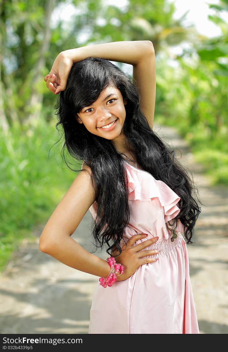 Portrait of young exotic girl smiling in green nature. Portrait of young exotic girl smiling in green nature