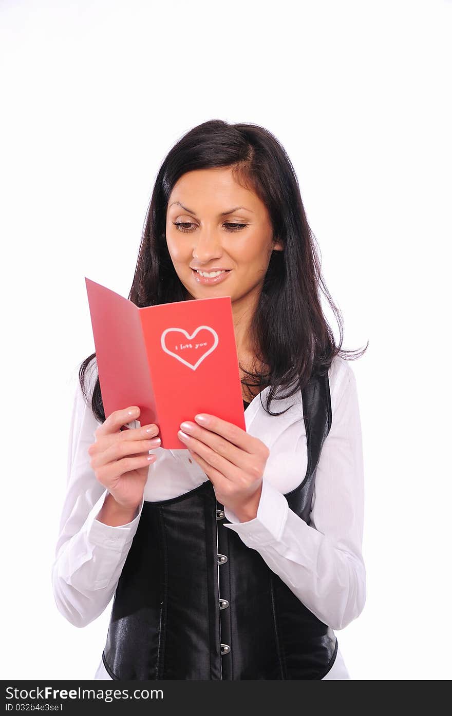 Young beautiful girl read a congratulatory postcard from Valentine's Day