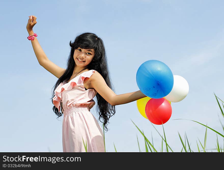 Happy Young Girl Playing Balloons