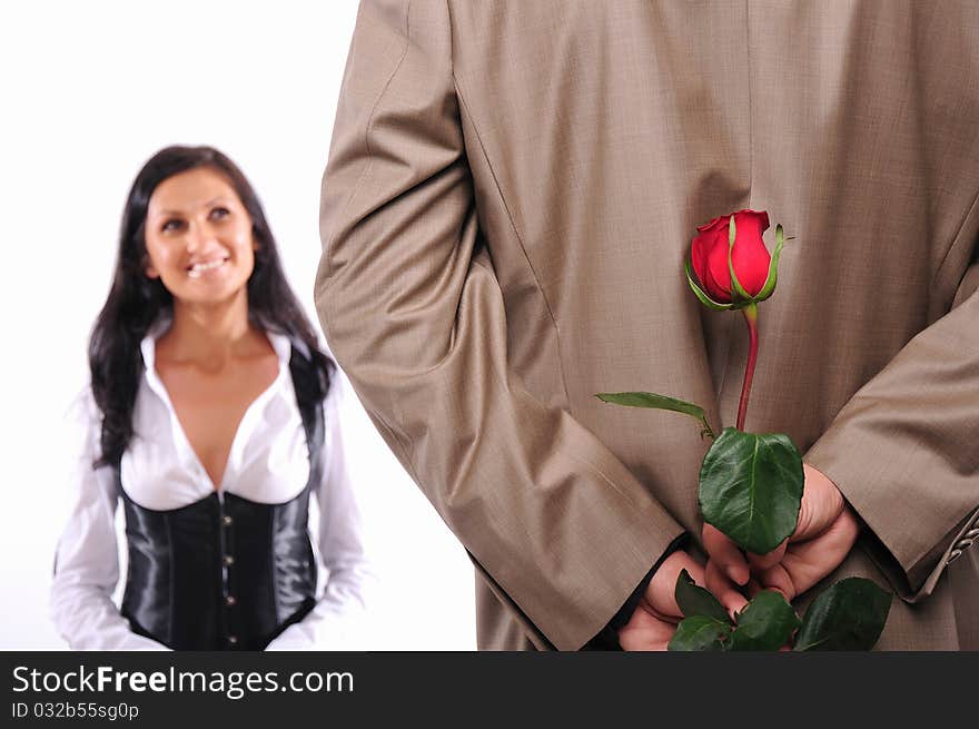 The young man gives his girlfriend a rose in honor of Valentine's Day