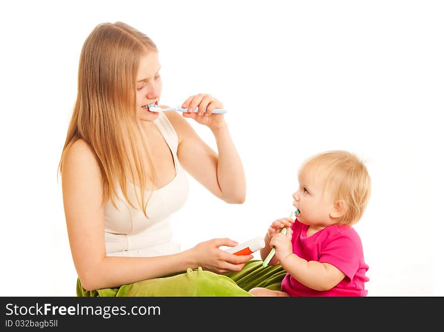 Woman and girl brushing tooth