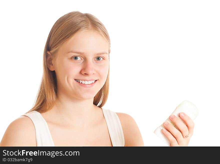 Portrait of young woman with deodorant in hand