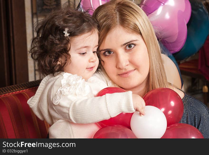 The happy woman holds the small daughter on hands. The happy woman holds the small daughter on hands.