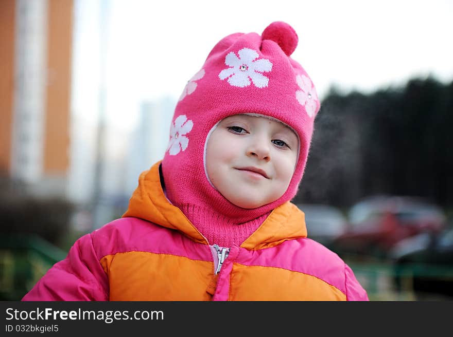 Portrait of small girl in warm pink hat. Portrait of small girl in warm pink hat