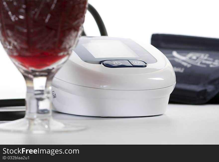 Blood pressure equipment with wineglass on foreground. Blood pressure equipment with wineglass on foreground