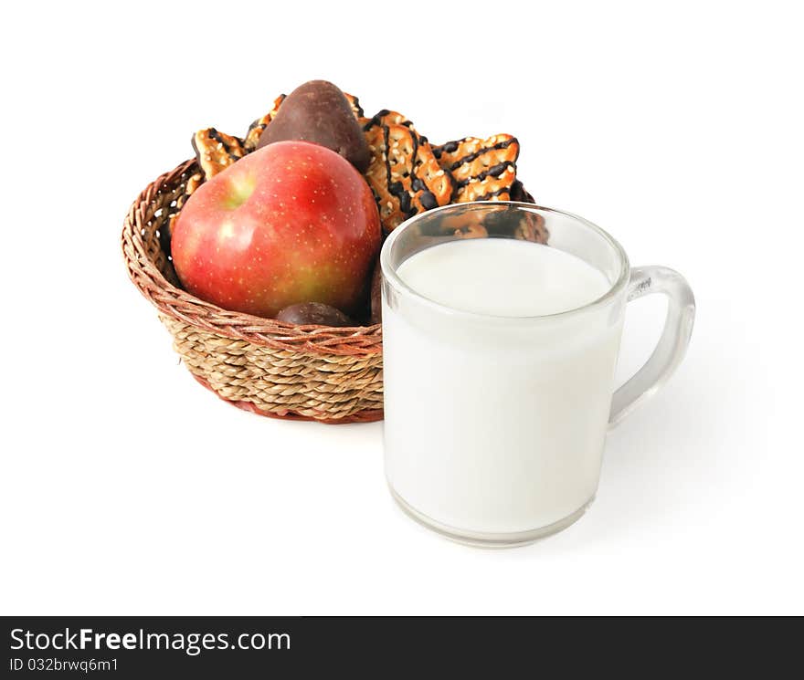 Cup of milk and cookies with apple in the basket for healthy breakfast