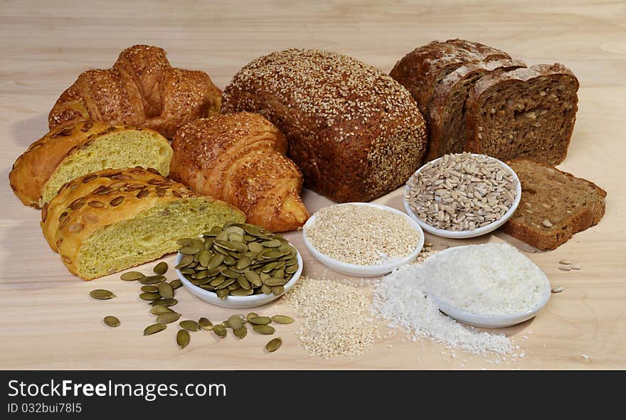 Variety of bread and ingredients on wooden background