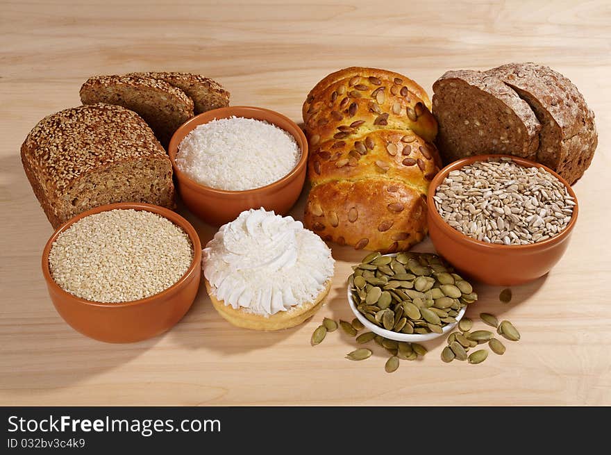 Variety of bread and ingredients on wooden background