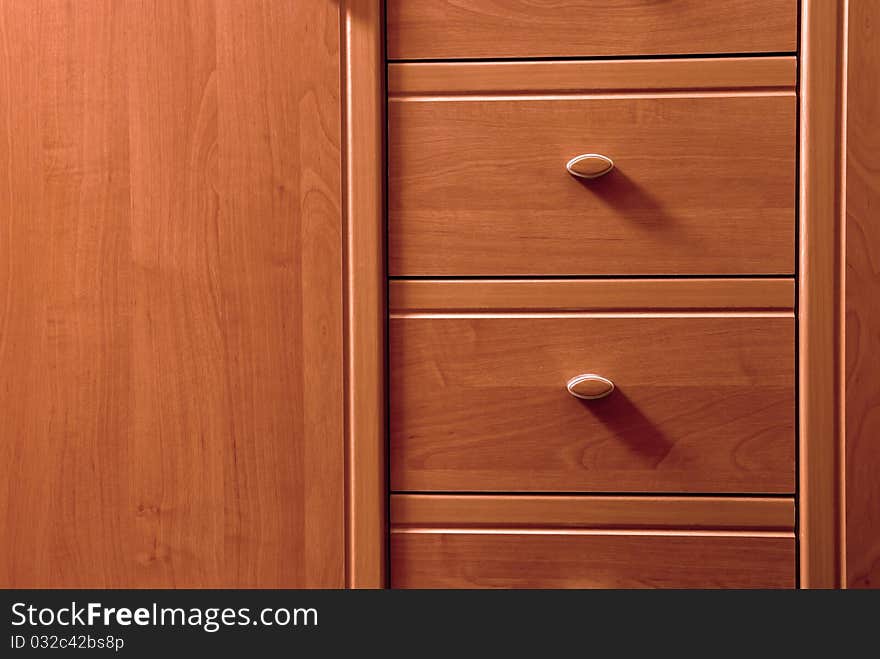 Detail of wooden chest of drawers. Detail of wooden chest of drawers