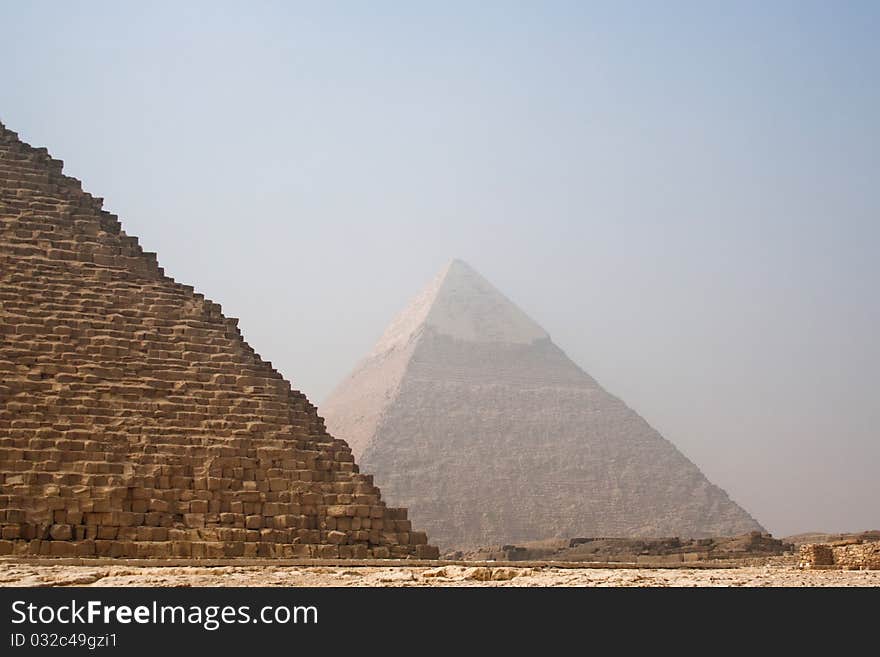 The Pyramid of Cheops (The Great Pyramid with the Pyramid of Khafre (Pyramid of Chefren) in the background, part of the Giza Necropolis in Egypt. The Pyramid of Cheops (The Great Pyramid with the Pyramid of Khafre (Pyramid of Chefren) in the background, part of the Giza Necropolis in Egypt.