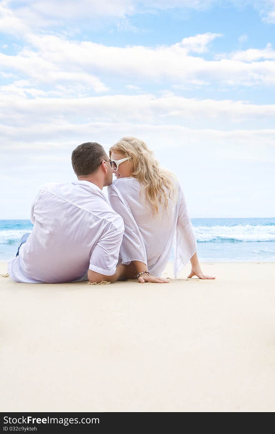 Portrait of young nice couple having good time on the beach