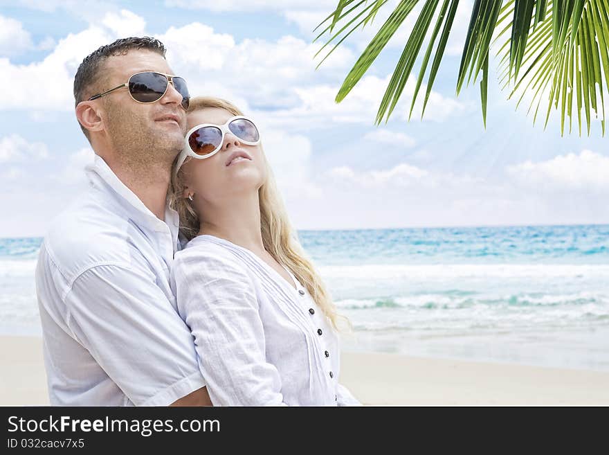 Portrait of young nice couple having good time on the beach. Portrait of young nice couple having good time on the beach