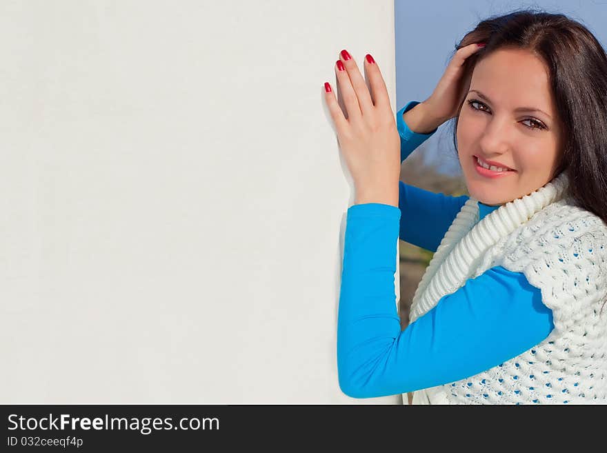 Beautiful sexy girl holding a blank billboard