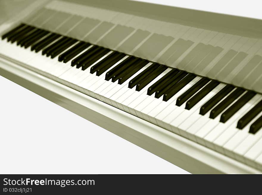 White grand piano with the open keyboard close up