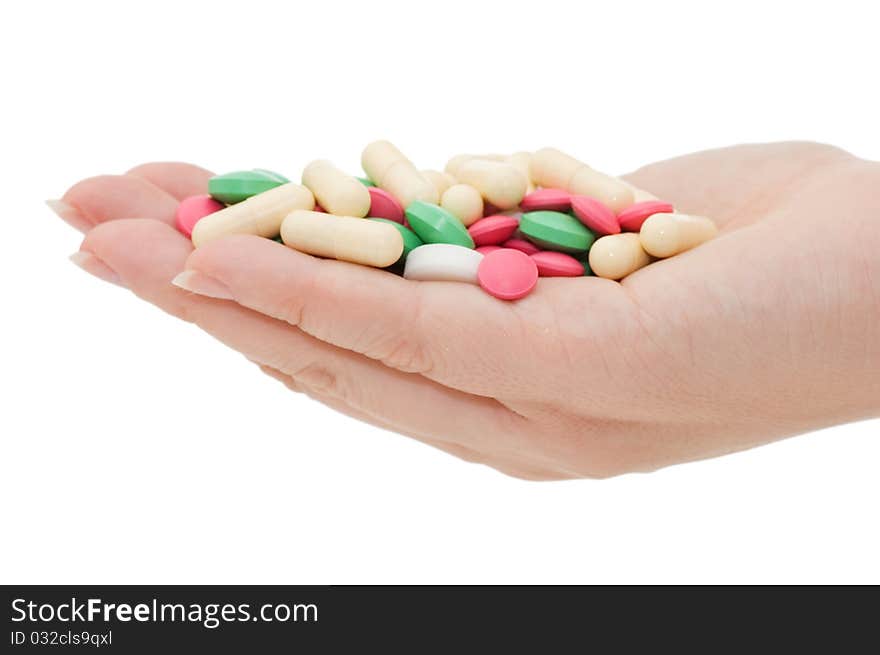 Hand with a pill on white background