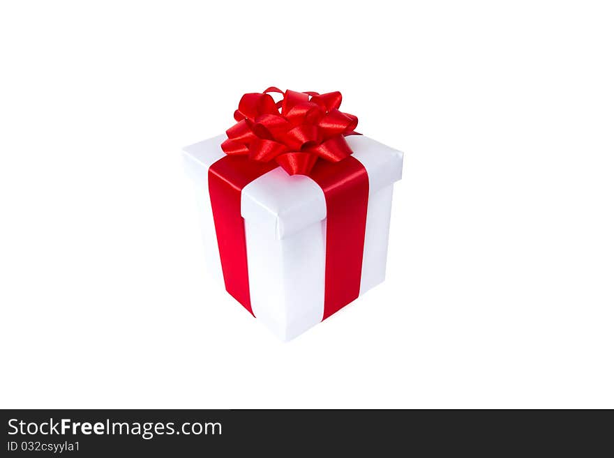 White gift box with red ribbon and bow isolated on white